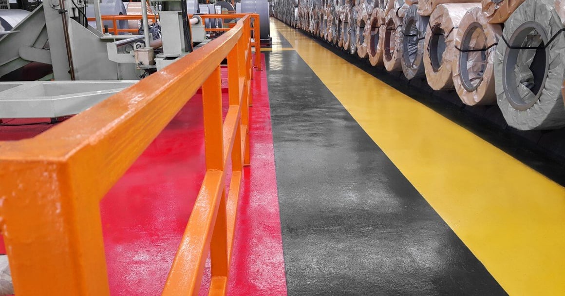 A warehouse inventory and a yellow stripe on the floor to the right. The left side has an orange barrier and a red stripe.